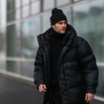 Muž v černé pánské péřové bundě, stylizace black total look